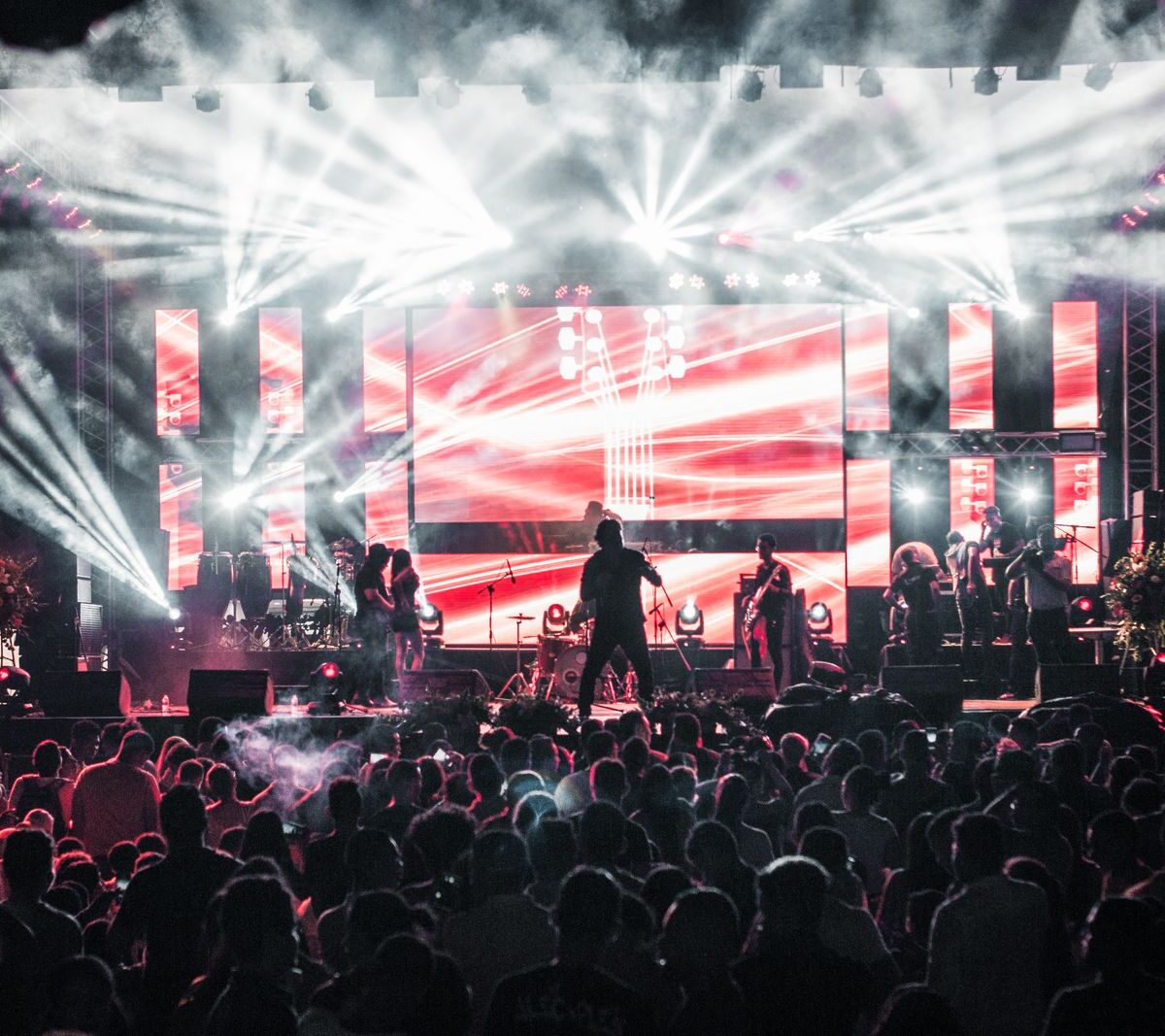 Crowd at a live music concert with bright stage lights