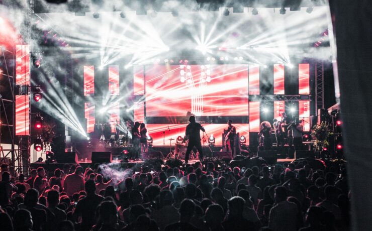 Crowd at a live music concert with bright stage lights