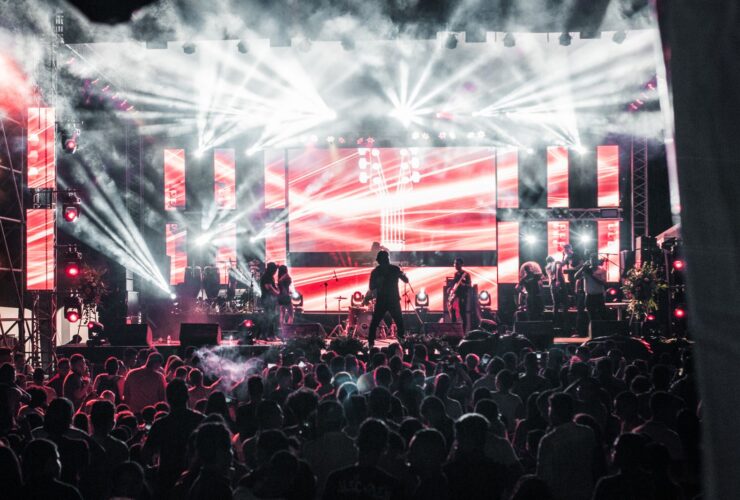 Crowd at a live music concert with bright stage lights