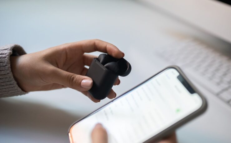 Listener connecting wireless earbuds to a smartphone music app