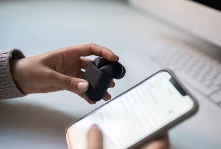 Listener connecting wireless earbuds to a smartphone music app