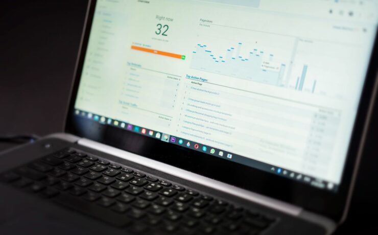 Laptop showing a real-time analytics dashboard with views and traffic charts